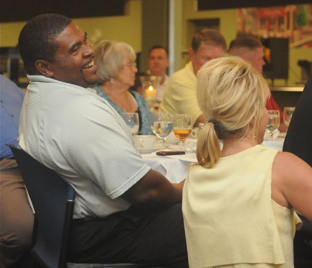 Head football coach Perry Thomas gets a laugh out of something Rhonda Smith tells him as items are being auctioned at the Annual CU Booster Dinner and Auction. (CU photo by Richard RoBards)