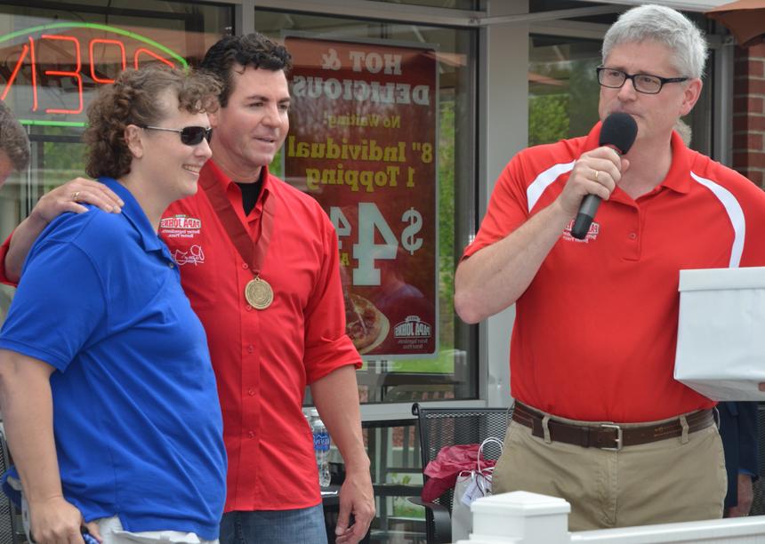 Samantha Burch, right, wife of Dr. John Burch, dean for library services and professor, was one of the winners at the  Papa John's grand opening. &quot;Papa&quot; John Schnatter, center, drew her name while local franchisee Ray Hibdon held the  box of entrants. (Campbellsville University Photo by Joan C. McKinney)