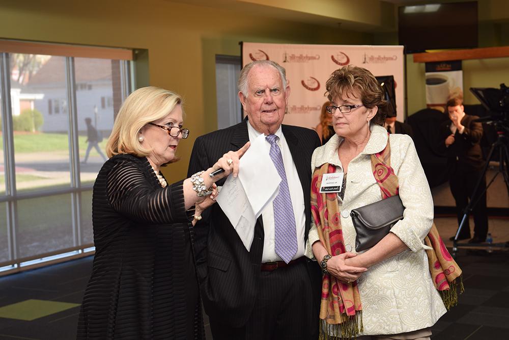 Gwinn Hahn, chair of the Derby Rose Gala, third from left, shows Carol Brown, on left, and Roy Rich, their seatings at Campbellsville University's 9th Annual Derby Rose Gala at Campbellsville University. (Campbellsville University Photo by Joshua Williams)